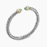 Silver bracelet with green gemstones on a white background featuring both Yellow Gold and Diamond on End Caps.