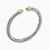 Silver bracelet with green gemstones on a white background featuring both Yellow Gold and Diamond on End Caps.