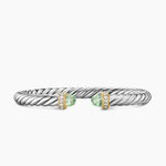 Silver bracelet with green gemstones on a white background featuring both Yellow Gold and Diamond on End Caps.
