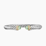 Silver bracelet with green gemstones on a white background featuring both Yellow Gold and Diamond on End Caps.