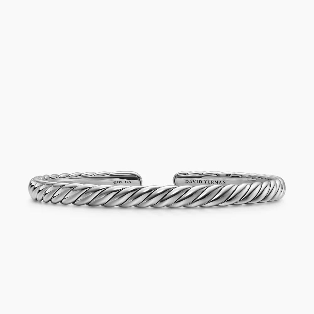 Silver bracelet with cable motif on a white background