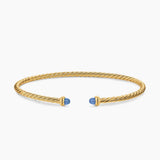 Gold bracelet with blue accents on a white background