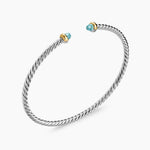 Open cable bracelet with two blue colors gemstones and mixed metal end caps. 