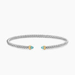 Open cable bracelet with two blue colors gemstones and mixed metal end caps. 