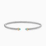 Open cable bracelet with two blue colors gemstones and mixed metal end caps. 