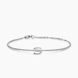 Silver bracelet with a letter 'S' charm on a white background