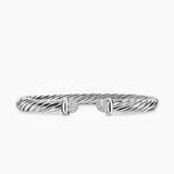 Silver bracelet with diamond accents on a white background