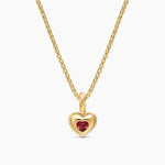 Back details of a yellow gold necklace with a red heart gemstone. 