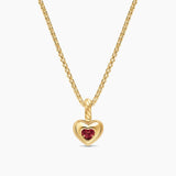 Back details of a yellow gold necklace with a red heart gemstone. 