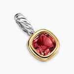 Amulet with red garnet gemstone and gold and silver accents on a white background
