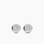 Pair of silver earrings with a diamond in the center on a white background