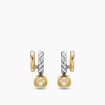 Pair of gold and silver earrings with yellow gemstones on a white background