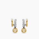 Pair of gold and silver earrings with yellow gemstones on a white background