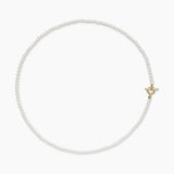 delicate pearl necklace with a gold clasp on a white background 