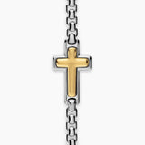 Up close image showing a gold cross pendant fixed onto a silver box chain