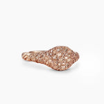 Rose gold ring with pave diamonds with a textured cable band on a white  background