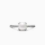 Silver cable ring with a pearl in the center on a white background
